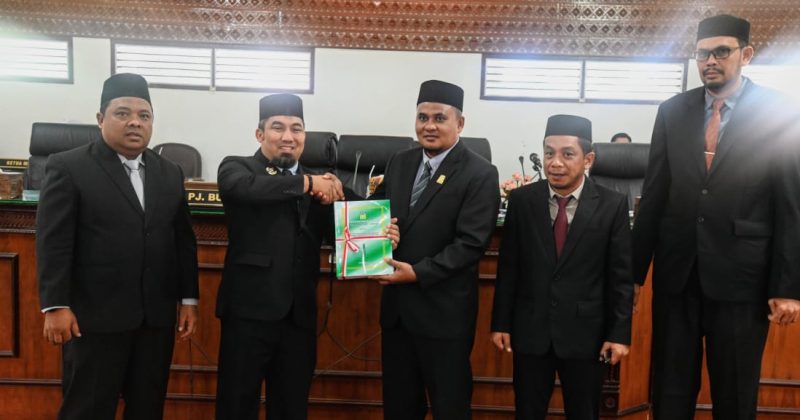 Pj Bupati Aceh Besar Muhammad Iswanto, S.STP MM didampingi Ketua TAPD sekaligus Sekda Aceh Besar Drs Sulaimi, menyerahkan Penyampaian Pengantar Nota Keuangan dan Rancangan Qanun Kabupaten Aceh kepada Wakil Ketua DPRK Zulfikar Azis SE yan didampingi Wakil Ketua Gunawan SE dan Sekwan Fata Muhammad, di Gedung DPRK Aceh Besar, Kota Jantho, Senin (24/06/2024). Foto: dok. MC Aceh Besar. 