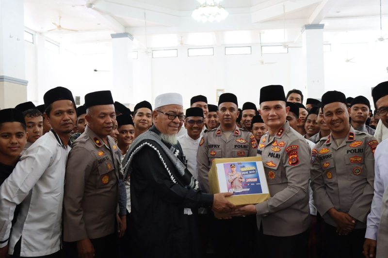 Kapolres Pidie Jaya AKBP Ahmad Faisal Pasaribu, S.H., S.I.K., M.H. saat memberikan memberikan cenderamata kepada Pimpinan Dayah Jeumala Amal. Foto: Polres Pidie Jaya