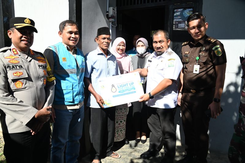 Pj Bupati Aceh Besar Muhammad Iswanto SSTP MM menyerahkan secara simbolis batuan listrik gratis dalam acara Pelayanan Serentak Program Light Up The Dream di Gampong Payah Ue, Kecamatan Blang Bintang, Aceh Besar, Rabu (23/10/2024). Foto: dok. MC Aceh Besar